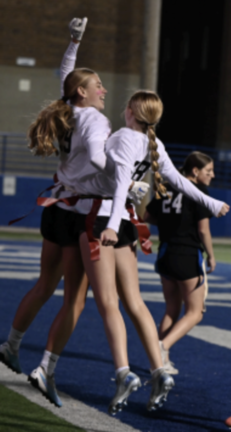 Kaylee Mills (11) and Katie Bucher (11) celebrate a touchdown. 
